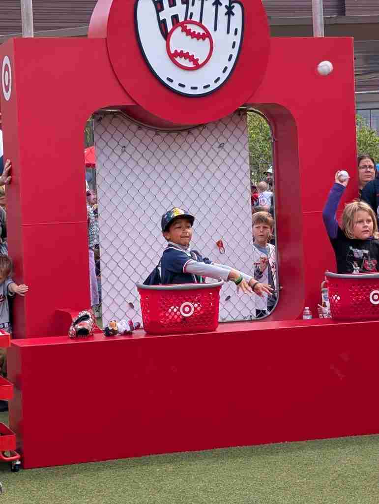 Boy throws a baseball at a Target Field Kids Day game