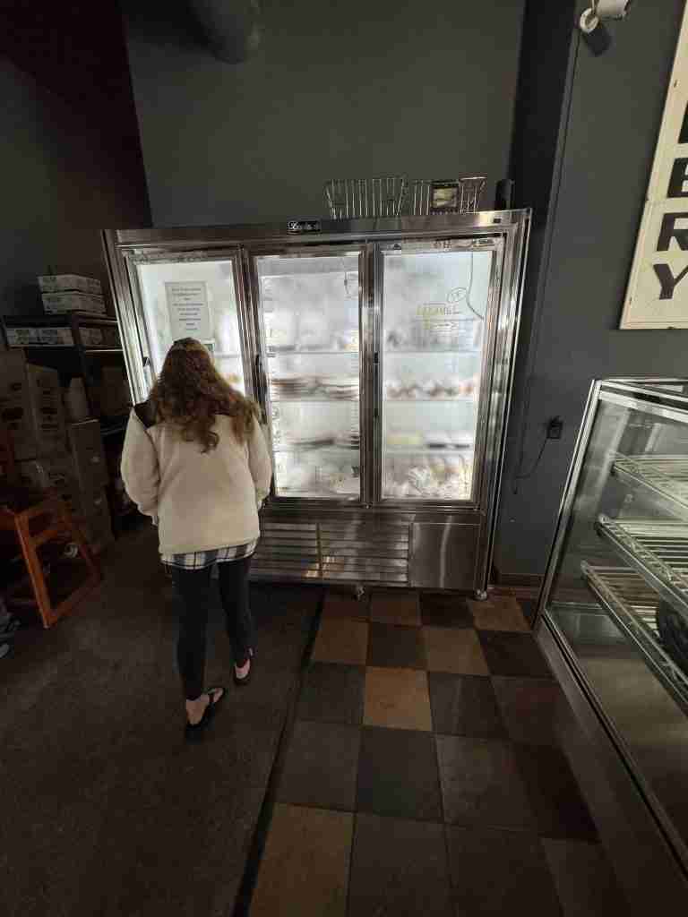 Jodi Moyer looks over the frozen case at Mehl's Gluten-Free Bakery