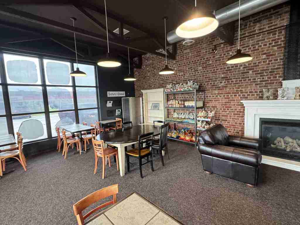 The dining room at Mehl's Gluten-Free Bakery with tables, pendant lights and a brick wall