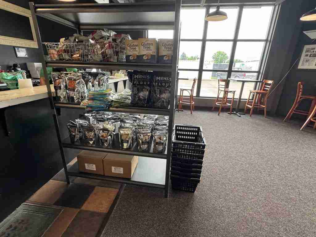 Bags of Mehl's Gluten-Free Flour and baking mixes on a shelf inside Mehl's Gluten-Free Bakery